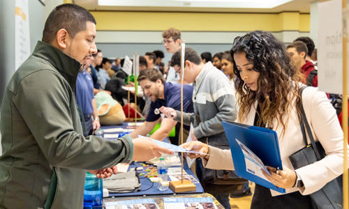 A student and employer meet at the Career Fair